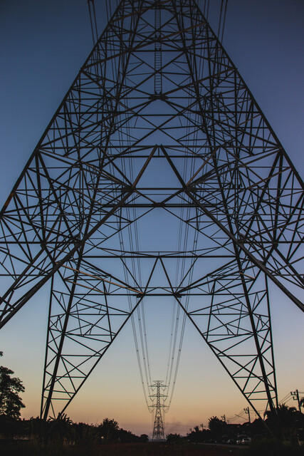 electricity transmission tower against evening sky