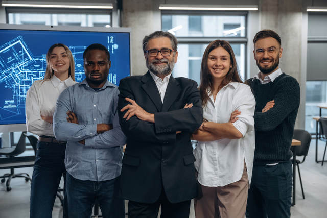 IT team standing in front of a blueboard